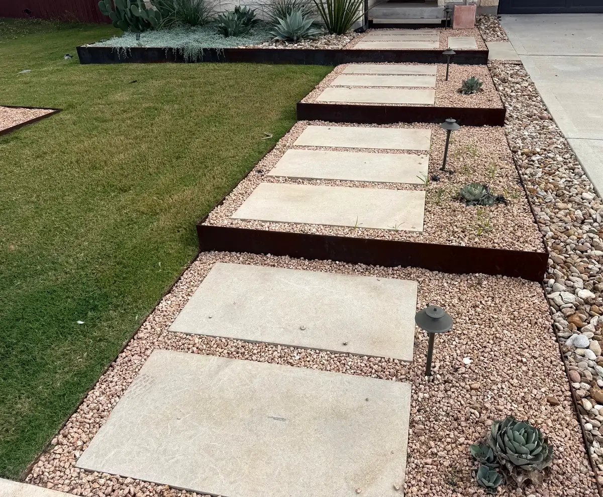 Steel-edged step pads with gravel, path lights and succulents